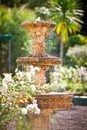 Bubbling fountain in courtyard garden Royalty Free Stock Photo