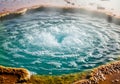 Bubbling hot spring features a circular pool of clear turquoise Royalty Free Stock Photo