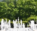 Bubbling water fountain againt trees Royalty Free Stock Photo