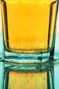 Bubbling yellow fizzy soda drink in glass, close up Royalty Free Stock Photo