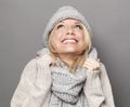 Bubbly young blonde woman smiling for warmth and cozyness in winter Royalty Free Stock Photo