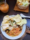 Bubur ayam, Indonesian chicken congee with spicy peanut sauce. Royalty Free Stock Photo