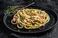 Bucatini Pasta with Smoked Salmon fillet and creamy spinach. Black background. Top view Royalty Free Stock Photo