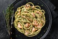 Bucatini Pasta with Smoked Salmon fillet and creamy spinach. Black background. Top view Royalty Free Stock Photo