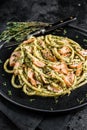 Bucatini Pasta with Smoked Salmon fillet and creamy spinach. Black background. Top view Royalty Free Stock Photo