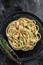 Bucatini Pasta with Smoked Salmon fillet and creamy spinach. Black background. Top view Royalty Free Stock Photo