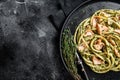Bucatini Pasta with Smoked Salmon fillet and creamy spinach. Black background. Top view. Copy space Royalty Free Stock Photo