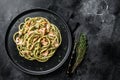 Bucatini Pasta with Smoked Salmon fillet and creamy spinach. Black background. Top view. Copy space Royalty Free Stock Photo