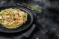 Bucatini Pasta with Smoked Salmon fillet and creamy spinach. Black background. Top view. Copy space Royalty Free Stock Photo