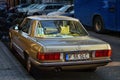 Old vintage beige Mercedes-Benz W123 with salad green seats. parked.