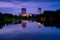 Bucharest office buildings at blue hour with lake reflection in summer time , Romania Royalty Free Stock Photo