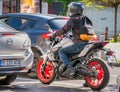 Biker on a motorcycle in traffic at the stoplight