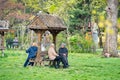 Group of senior women people sitting down on benches in the park and socializing. Landscape in