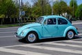 Bucharest, Romania, 24 April 2021 Old retro vivid blue turquoise Volkswagen Beetle classic car in traffic in a street in a sunny Royalty Free Stock Photo