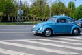 Bucharest, Romania, 24 April 2021 Old retro vivid blue turquoise Volkswagen Beetle classic car in traffic in a street in a sunny Royalty Free Stock Photo