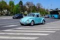 Bucharest, Romania, 24 April 2021 Old retro vivid blue turquoise Volkswagen Beetle classic car in traffic in a street in a sunny Royalty Free Stock Photo