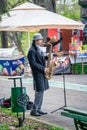 Street musician man playing at saxophone in King Mihai I park ( Herestrau), in Bucharest Royalty Free Stock Photo