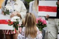 Details with a little girl holding flowers during a political rally supporting the protests in Belarus