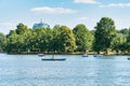 Many people in boats paddling on the lake in King Mihai I park (Herestrau). Couple on a