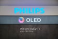 Philips and Oled logos displayed in eMAG showroom, in Bucharest, Romania, advertising their 4K TVs