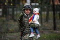 Romanian army soldier holds his child in his arms during the Romanian National Day military parade