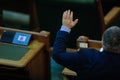 Romanian senators vote bills by raising their hands in a full Senate meeting