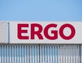 ERGO is a group of insurance companies owned by Munich Re. Company logo against blue sky