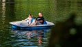 Bucharest, Romania - 2019. Family relaxing on pedal boat on hot sunny day in Cismigiu Gardens Lake