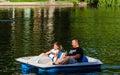 Bucharest, Romania - 2019. Family relaxing on pedal boat on hot sunny day in Cismigiu Gardens Lake