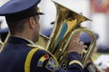 Details with the hands of a military fanfare member holding a brass wind musical instrument Royalty Free Stock Photo