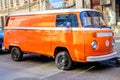 Bucharest, Romania, 2 January 2021 Old vivid orange Hippie Volkswagen Kombi van parked a street in a sunny day
