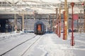 A train is leaving the Northern Railway Station Gara de Nord during a cold, sunny and snowy day in Bucharest Royalty Free Stock Photo