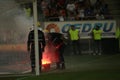 Firefighter tries to extinguish torches thrown on the grass