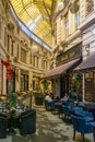 BUCHAREST, ROMANIA - 27 JULY, 2019: Restaurants at the Macca Villacrosse Passage - a fork-shaped, yellow glass covered arcaded