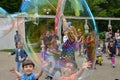 Happy children play with soap bubbles in the park Royalty Free Stock Photo