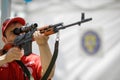 Shallow depth of field selective focus image with a Romanian paramedic aiming a Dragunov sniper rifle during an exhibition