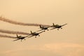 Silhouette of airplanes performing acrobatic flight at sundown. Trace of Smoke behind it Royalty Free Stock Photo