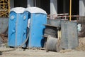 A worker is emptying ecological toilets on a construction site