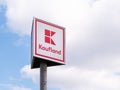 Kaufland logo on a sign board against blue sky. Kaufland is a German hypermarket chain, part of