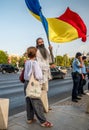 Bucharest/Romania - 09.19.2020: Man waving a big Romanian flag as a part of the Protest in the University square against wearing Royalty Free Stock Photo