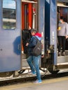 Man with big luggage getting on the train at North Railway station in Bucharest Royalty Free Stock Photo