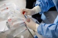 Details with the hands of a medic using a coronavirus test on a person