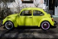 Bucharest, Romania, 3 March 2021 Old retro yellow Volkswagen Beetle classic car parked a street in a sunny spring day Royalty Free Stock Photo