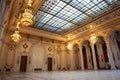 BUCHAREST, ROMANIA - MARCH 13, 2023: Selective blur on doors & opulent design with crystal chandeliers of hall in interior of