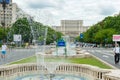 BUCHAREST, ROMANIA - MAY 30, 2017: Bucharest Cityscape with Street Fountain and Empty Street. Parliament in Background