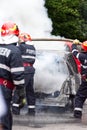 Firemen extinguishes the car on fire