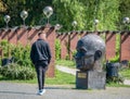 Single man out for a stroll on the alleys in King Mihai I park (Herestrau