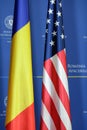 US and Romania flags with the Romanian Foreign Affairs Ministry logo on the background