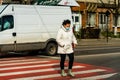 Pedestrian crossing the street with the zebra crossing in Bucharest, Romania