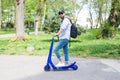 Man using blue electric scooter in the park